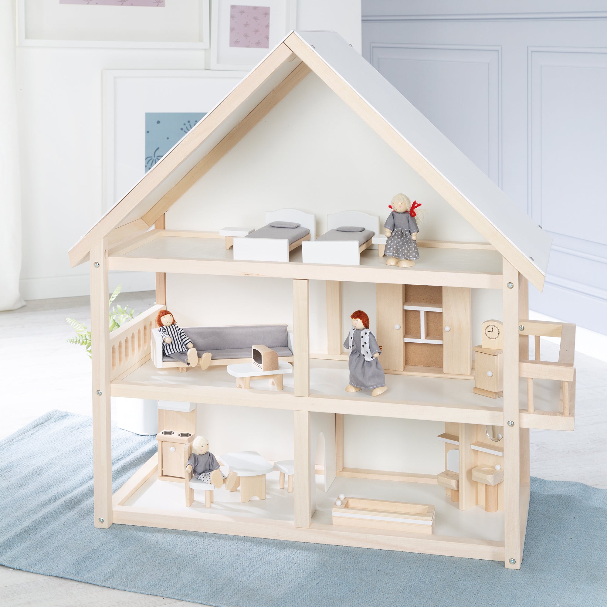 Puppenhaus für Kinder hergestellt aus Holz mit Einrichtungsmöbeln und Spielpuppen