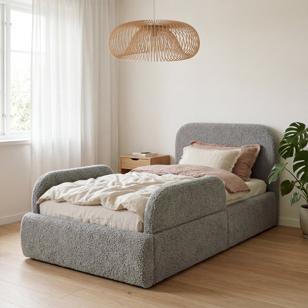 Grey bouclé children's bed with fall protection in a bright room with a rattan lamp and a plant. Fully AI-generated.