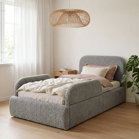 Grey bouclé children's bed with fall protection in a bright room with a rattan lamp and a plant. Fully AI-generated.