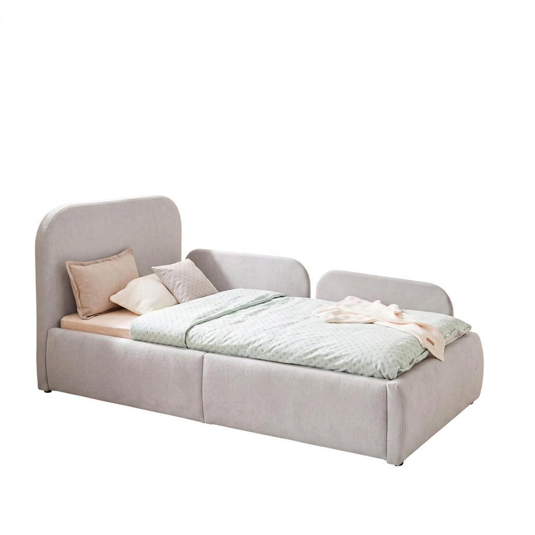 Cama infantil gris claro de bouclé con protección anticaídas, ropa de cama color menta, imagen recortada.