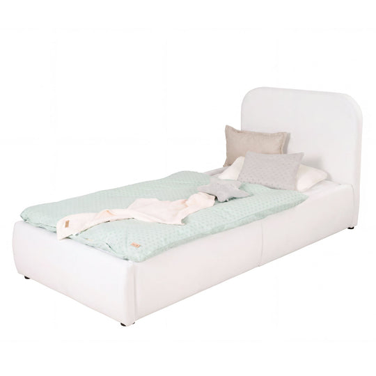 White bouclé children's bed with fall protection and mint bed linen, cut-out image.