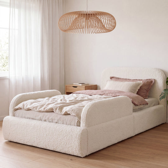 White bouclé children's bed with fall protection, rattan lamp and pink bed linen in the room. Fully AI-generated.
